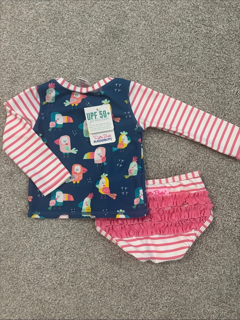 Ruffle Butts Navy Tropical Bird Rashguard Set with Pink Stripes
